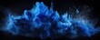 Explosion of indigo blue colored powder on black background