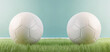Two white football balls placed against each other on the green grass. Soccer scoreline symbols with copy space for match announcements. Tournament rivalry