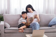 © Rakchanok - Cute Asian preschool boy happy listening storybook from mother spent free time together bonding relationship in weekend, female mom reading book for kid after teaching homeschool distance learning