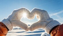 Female Hands In Winter Gloves Shaped Heart Symbol. Blue Sky In The Background	
