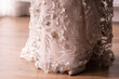 Detail of an elegant cream colored lace party dress