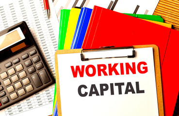 WORKING CAPITAL text written on paper clipboard with chart and calculator