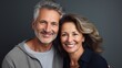 © Wolfilser - An older, middle-aged couple is happy, having fun and laughing indoor