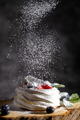 Wall Mural - Powdered sugar decorates Pavlova's dessert. Baking desserts at home