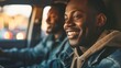 © progressman - two men are smiling while driving a car