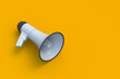 Megaphone on yellow background. Advertising and distribution. Announcing a new event. Inspirational speech. Call for protest. Danger warning. Discount and sale concept. Copy space. 3d render