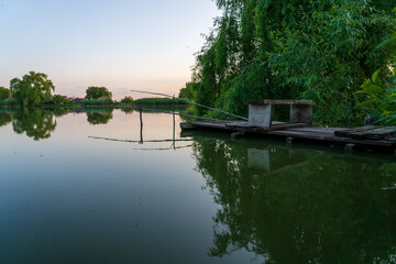 Wall Mural - Fishing spot in the village. Background with selective focus and copy space