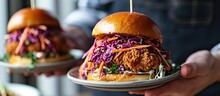 Holding Crispy Chicken Sandwiches With Slaw Salad.