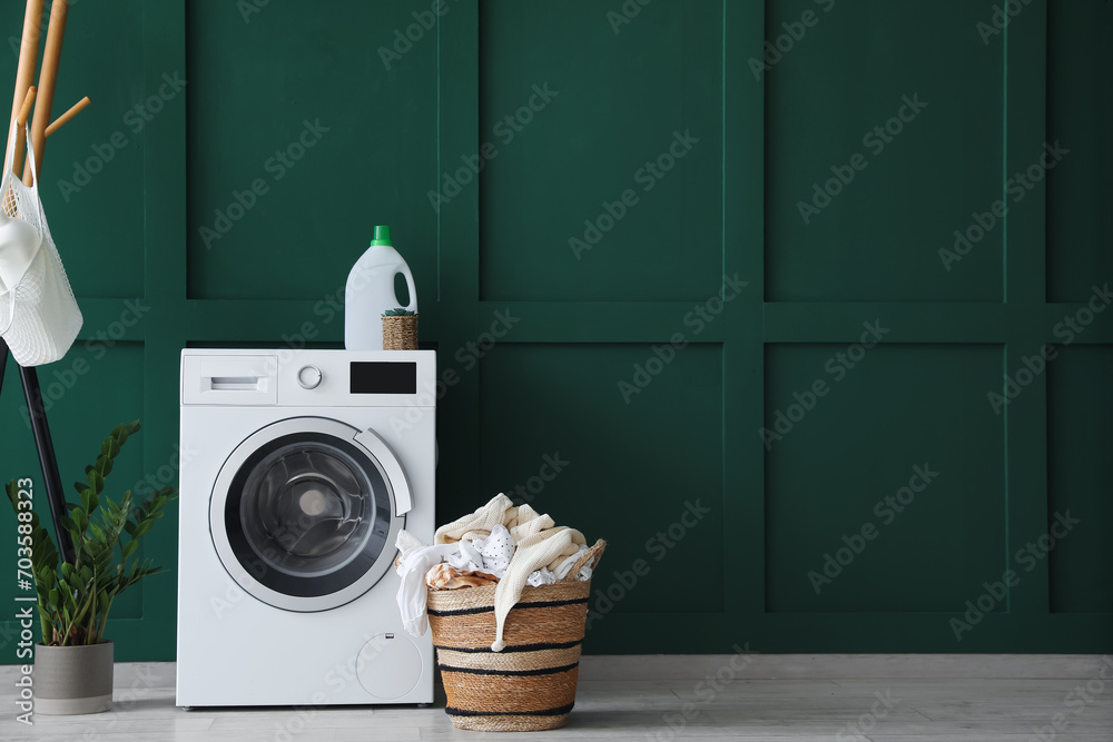 Interior of laundry room with washing machine, basket and rack