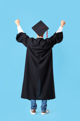 Canvas Print - Male graduate student on blue background, back view