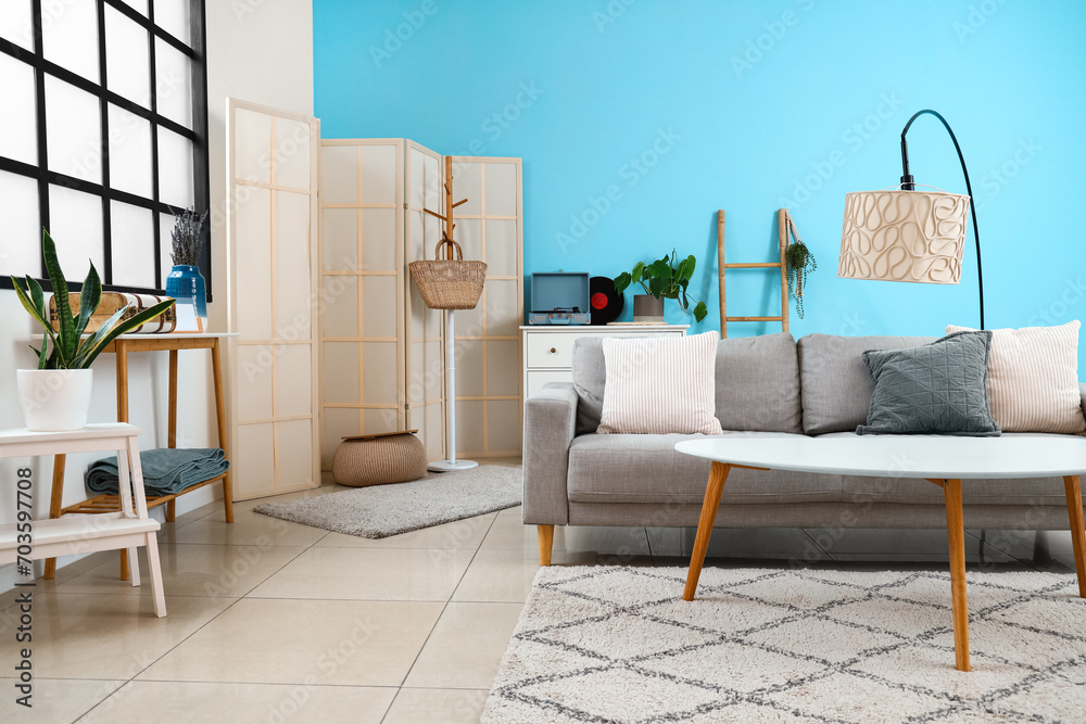 Interior of stylish living room with sofa, table and lamp