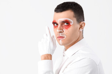 Poster - Young man with painted face on white background, closeup