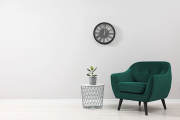 Canvas Print - Comfortable armchair and coffee table near light grey wall indoors. Space for text