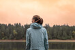 © kieferpix - Fale traveler thinking standing in nature forest lake setting looking out at the beautiful misty winter sunrise view