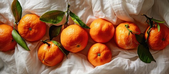 Wall Mural - Ripe clementines arranged vertically on white cloth.