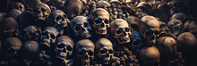 Pile Of Death Human Skulls And Bones Of Dead In Ancient Crypt Grave Burial. Skeletons In A Dark Scary Catacombs Dungeon
