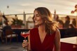 Beautiful young woman in a red dress with a glass of wine in the restaurant