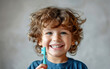 Smiling child boy holding a toothbrush