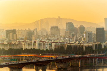 Wall Mural - Gold sun risae or sunset of Seoul cityscapes with high rise office buildings and skyscrapers in Seoul city, Republic of Korea in winter blue sky and cloud