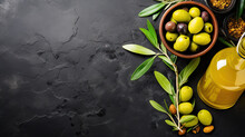 Olive Oil Bottle And Olives On Dark Slate  Background, Top View,  Copy Space For Text