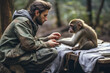 A male volunteer helps an injured monkey in the wild. The concept of wildlife rescue and conservation