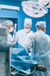 © johnalexandr - Doctors surgeons perform an operation in a hospital