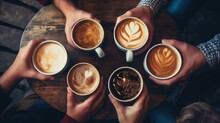 
A Top-view Photo Capturing People's Hands As They Hold Mugs Of Coffee