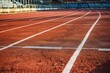 Red running track at the track and field stadium, low angle. The rough pavement is delineated with white lines.