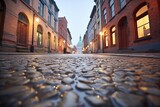 Fototapeta Uliczki - wet cobblestone alley reflecting dim light after rain