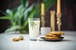glass of cannabis-infused milk beside a stack of cookies