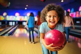 Kids having fun in a bowling alley.
