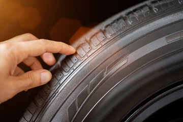 Wall Mural - Closeup of the tread of a summer car tire on a sunny day. tires against black. fuel efficient car tires.