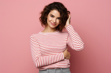 Wall Mural - Cheerful Afro-American Woman with Curly Hair in Stylish Striped Shirt, Posing with a Happy Smile in Studio with Blue Background