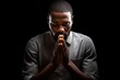 african american man praying on black background, praying to god with religious
