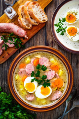 Sticker -  Sour rye soup with sausages and boiled eggs on wooden table