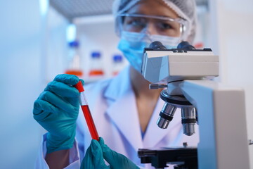 Science test tubes, laboratory equipment for new medical research, microbiology research with small pipettes in close-up. Asian and African female scientists in the laboratory, perfume samples