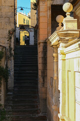 Romantic backstreet, side street or alley in historic old town of Genoa, Italy with historic Mediterranean style architecture facades, a landmark sightseeing tourist spot in downtown	