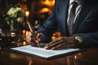 © Gonzalo - Businessman in a suit signs a contract for the purchase of a property