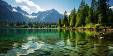Serene Green Lake Nestled In The Heart Of Towering Mountains, Under A Clear, Sunny Sky