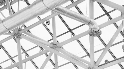 Poster - Ventilation pipes in silver insulation material hanging from the ceiling inside new building.
