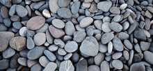 Smooth Round Pebbles Texture Background. Pebble Sea Beach Close-up, Dark Wet Pebble And Gray Dry Pebble. High Quality Photo