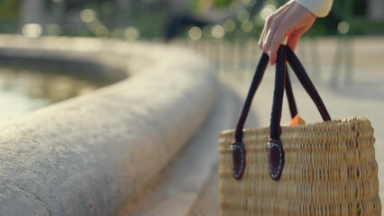 Wall Mural - A student putting a book into her bag in the Tuileries Gardens