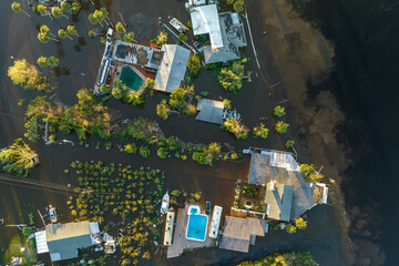 Wall Mural - Heavy flood with high water surrounding residential houses after hurricane Ian rainfall in Florida residential area. Consequences of natural disaster