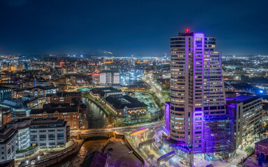 Leeds city centre at Night. Yorkshire city of Leeds after dark with city centre lights of offices, apartments and retail. Aerial view from near the train station