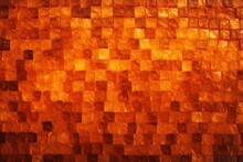  A Close Up Of A Wall Made Up Of Small Squares Of Orange And Yellow Squares Of Varying Sizes And Shapes With A Black Dot In The Middle Of The Middle.