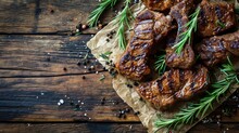  A Bunch Of Meat Sitting On Top Of A Piece Of Wax Paper Next To A Sprig Of Rosemary On Top Of A Piece Of Parchment Paper On A Wooden Table.