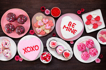 Aufkleber - Valentines Day table scene with a variety of fun desserts and sweets. Top down view on a dark wood background. Love and hearts theme.