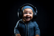 portrait of a crazy baby in headphones on a black background