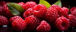 Close-up image of fresh raspberries with green leaves