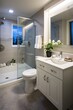 Small bathroom interior with white vanity and grey tiles